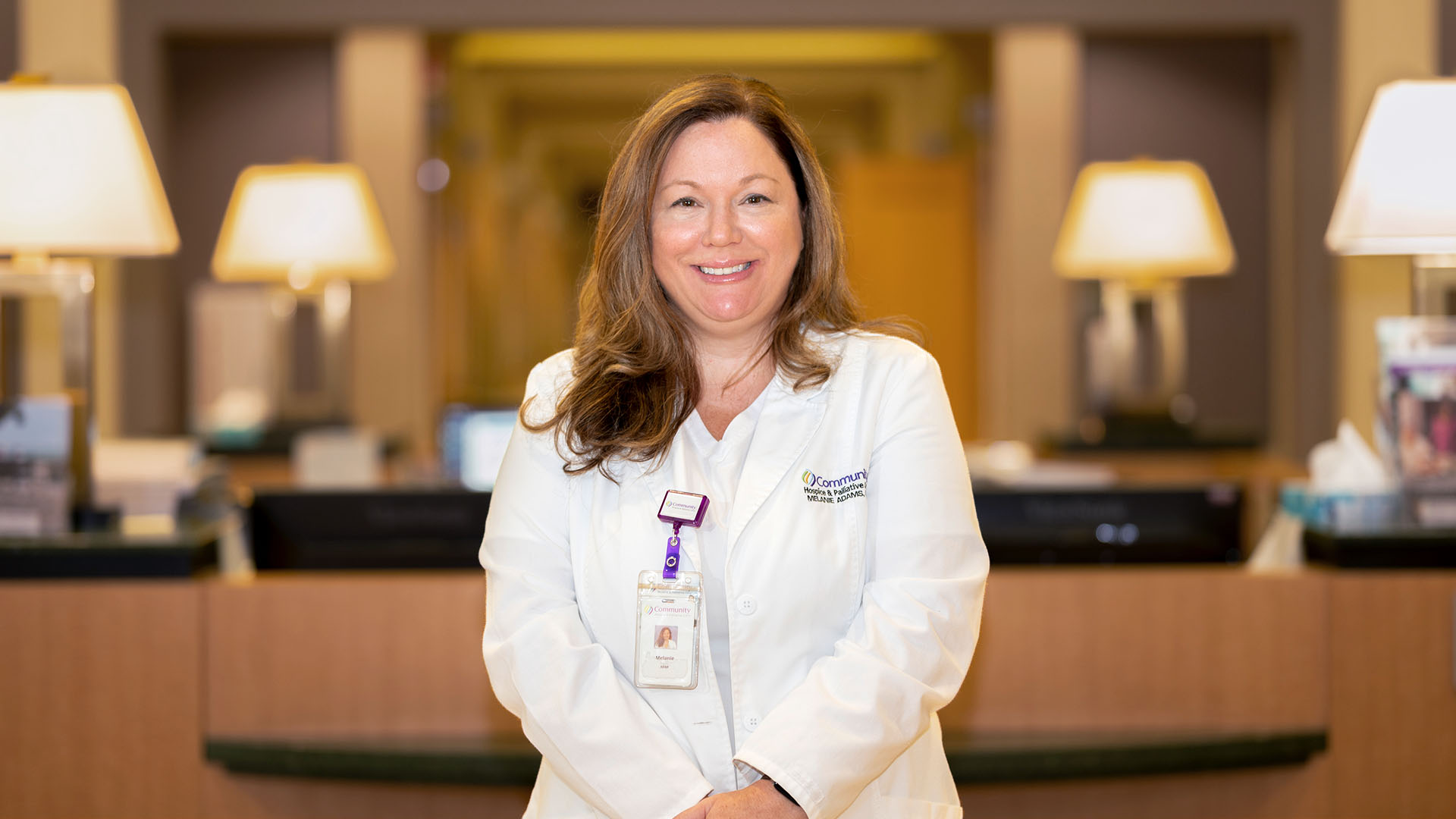 Melanie Adams, ARNP, ACHPN, in front of the Hadlow Nursing Station