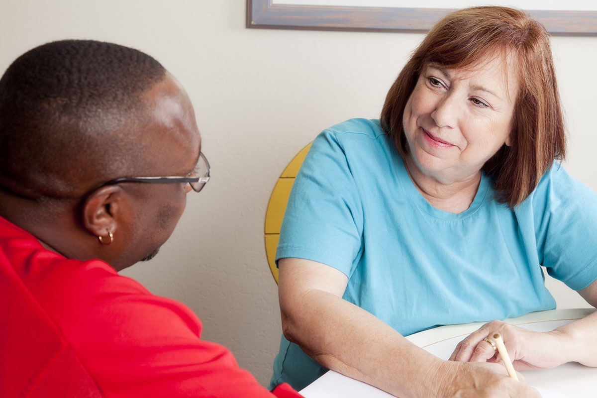 Social worker interviewing african american man