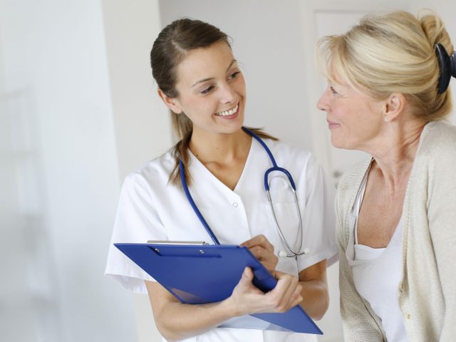 Nurse giving presciption to elderly woman Nurse giving presciption to elderly woman